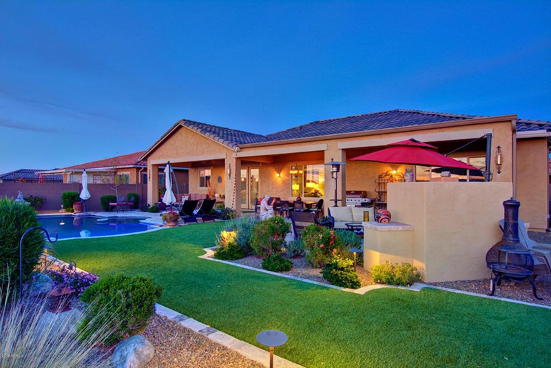 Tierra Del Rio backyard with pool and covered patio at dusk
