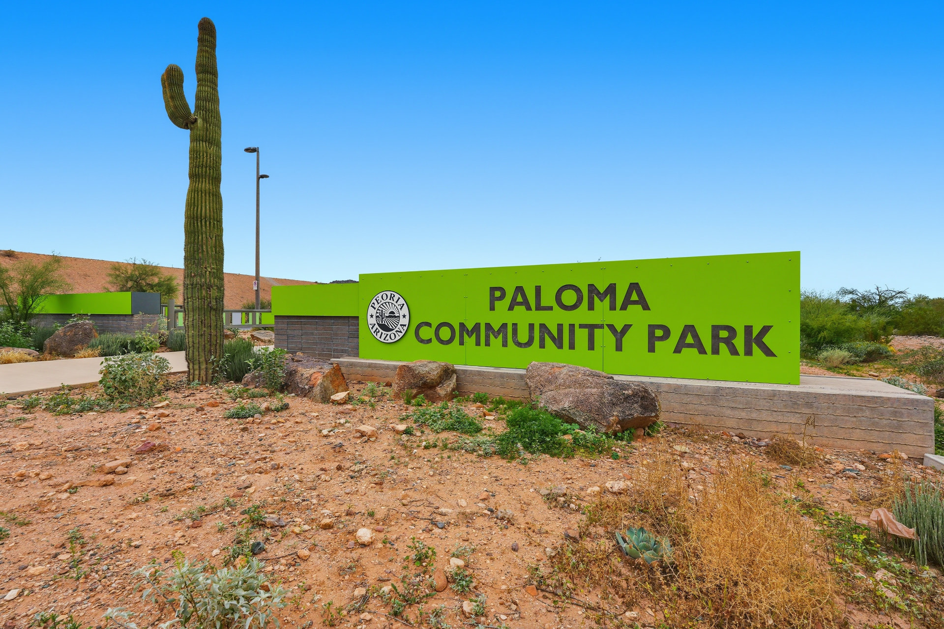 Entrance sign at Paloma Community Park in north Peoria, Arizona, with saguaro cactus
