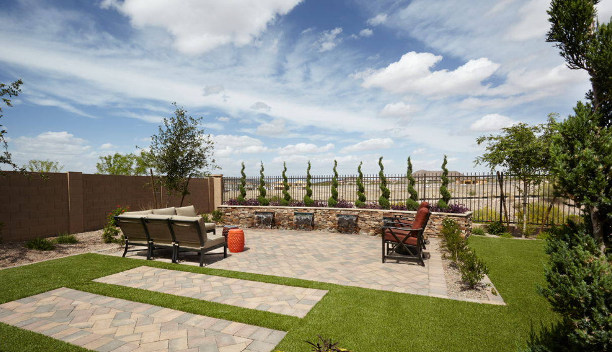 Landscaped backyard with paver patio and desert views