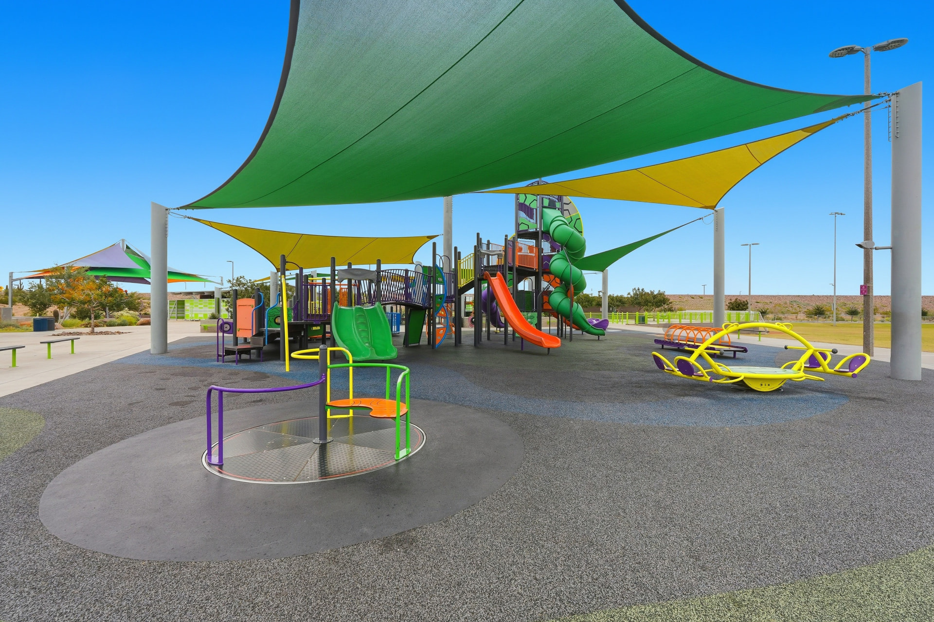 Large shaded playground with slides and spinners at Paloma Community Park, Peoria AZ